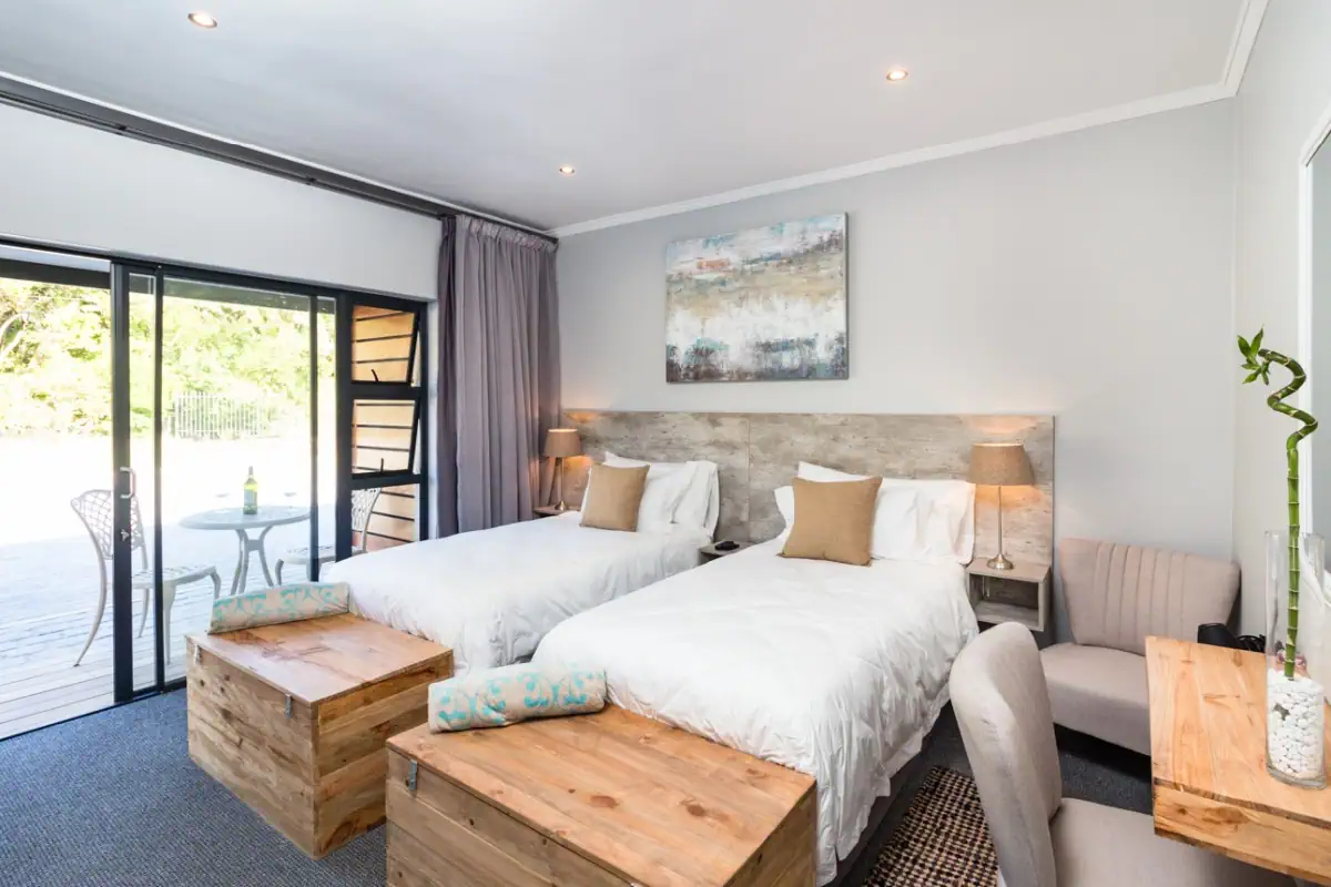 Room with two beds with view to the patio