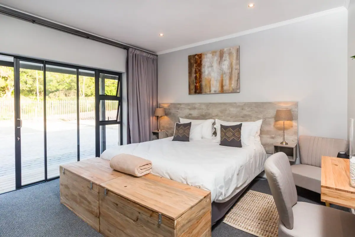 The room with a king-size bed with view to the patio
