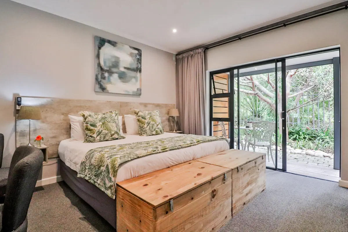 The room with a king-size bed with view to the patio